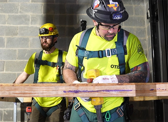 IUEC Otis mechanics during an installation of new construction elevators